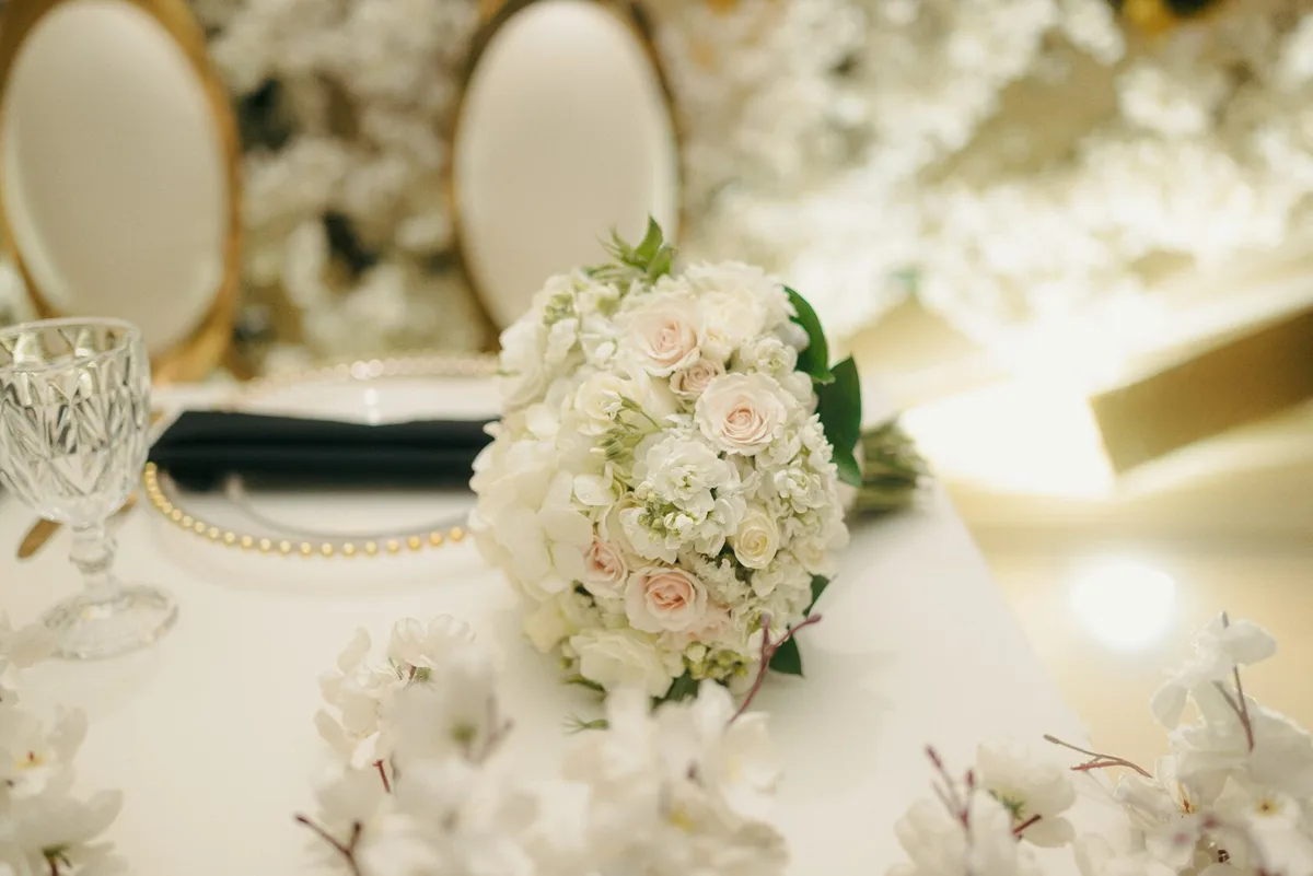 White rose and hydrangea bouquet arranged on an elegant table